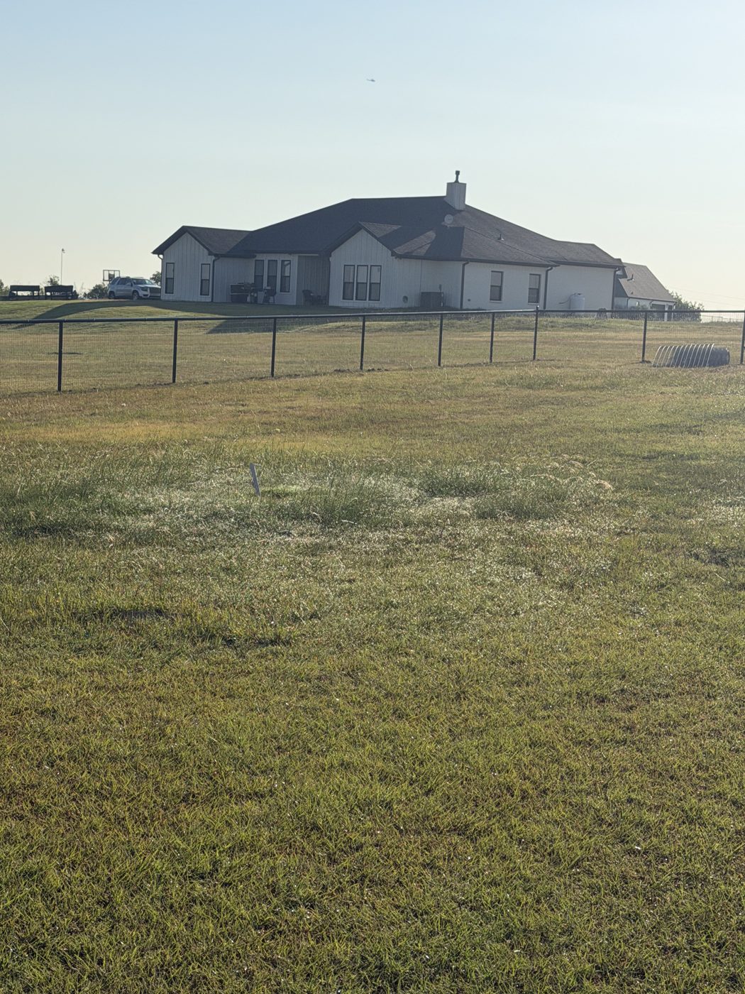Field fence around a ranch house property