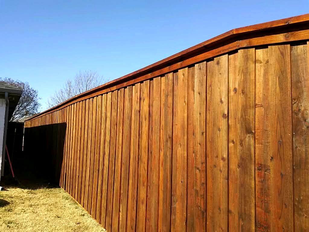Close-up of a finished stained wood fence