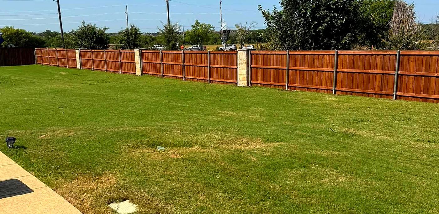 Long wood fence line with stone pillars