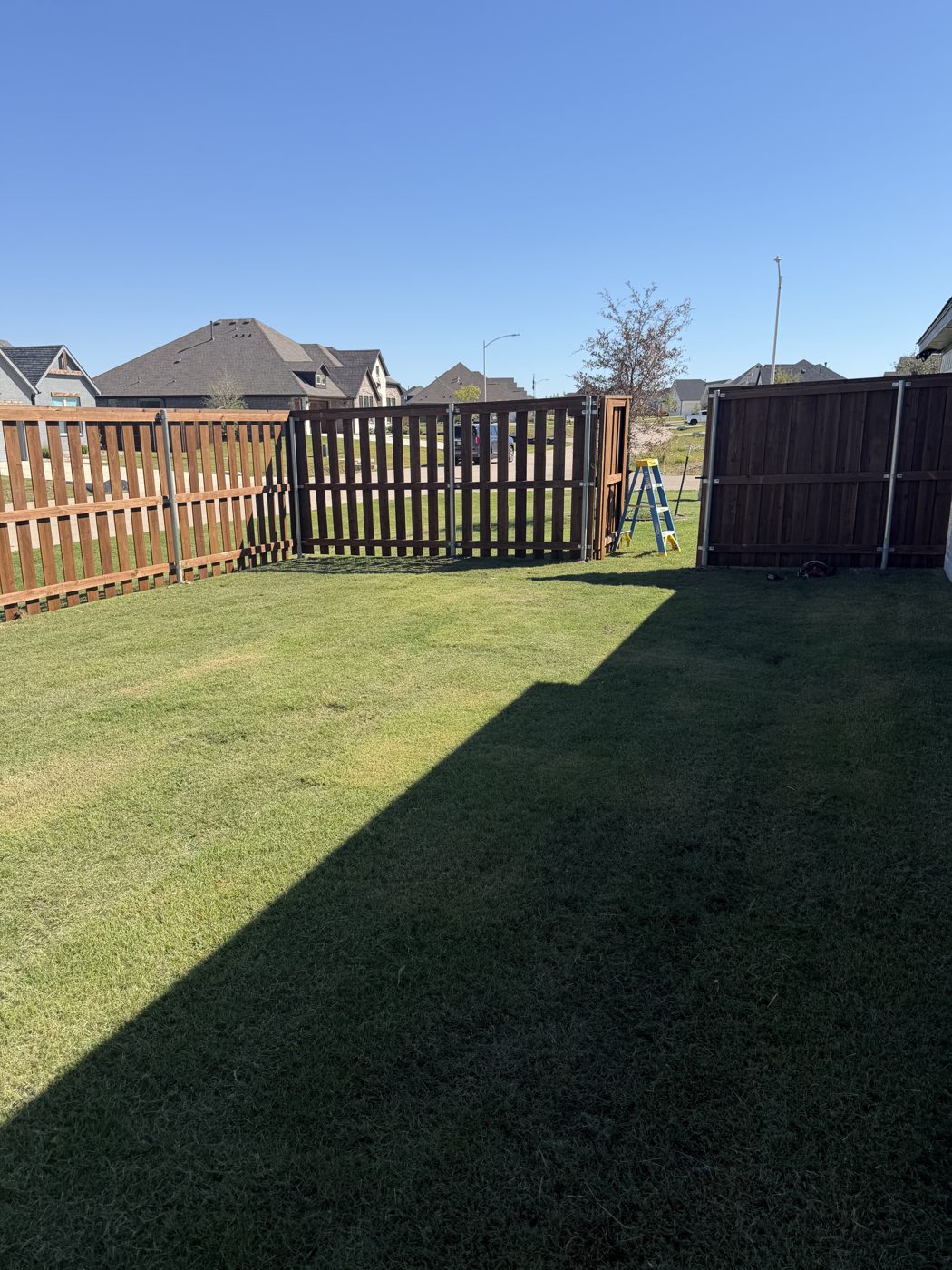 Wood fence corner with an open gate