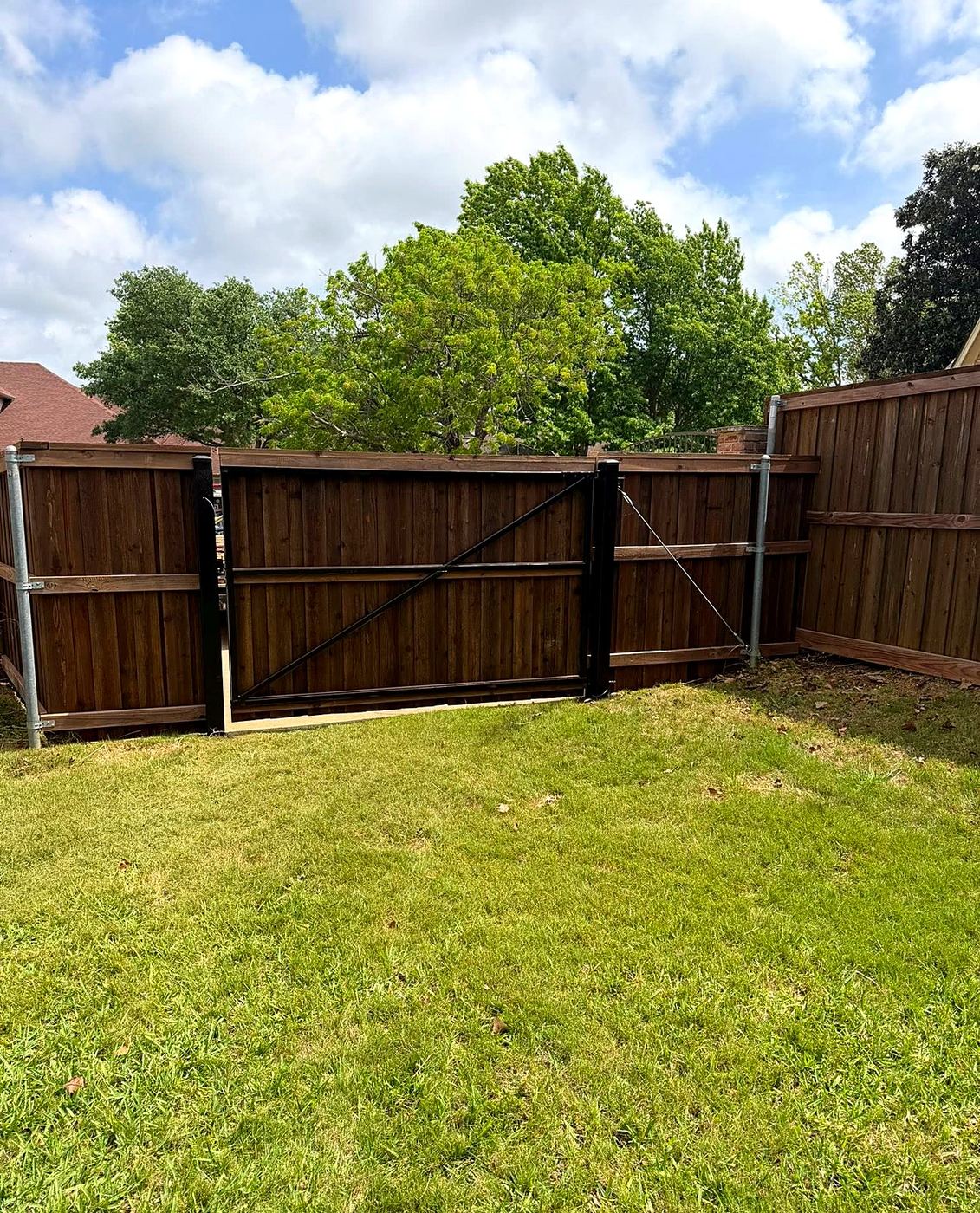 Wood fence with matching gate in backyard