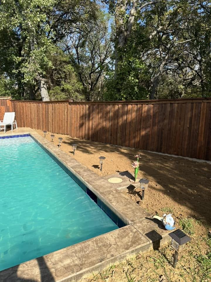 Wood privacy fence enclosing a backyard pool