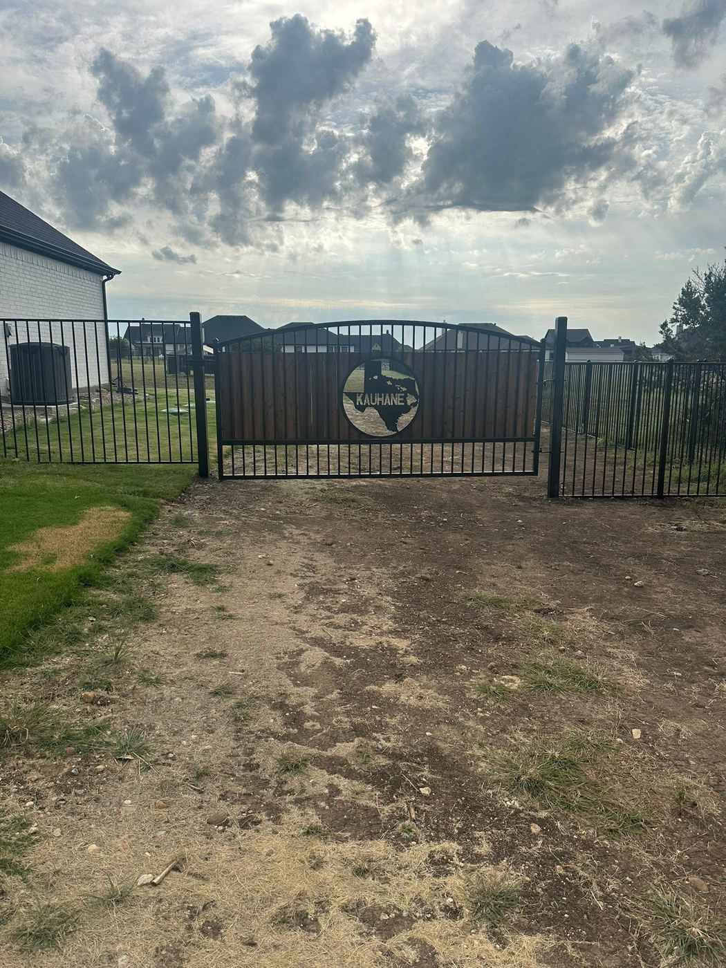 Custom ornamental gate with a personalized Texas medallion
