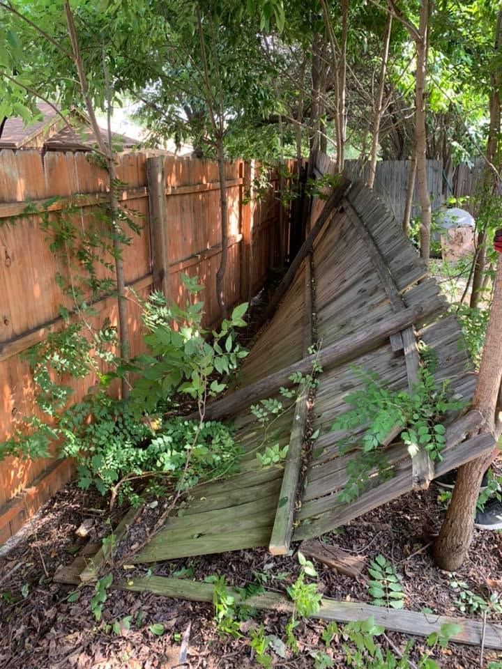 Leaning, damaged wood fence panel in need of repair