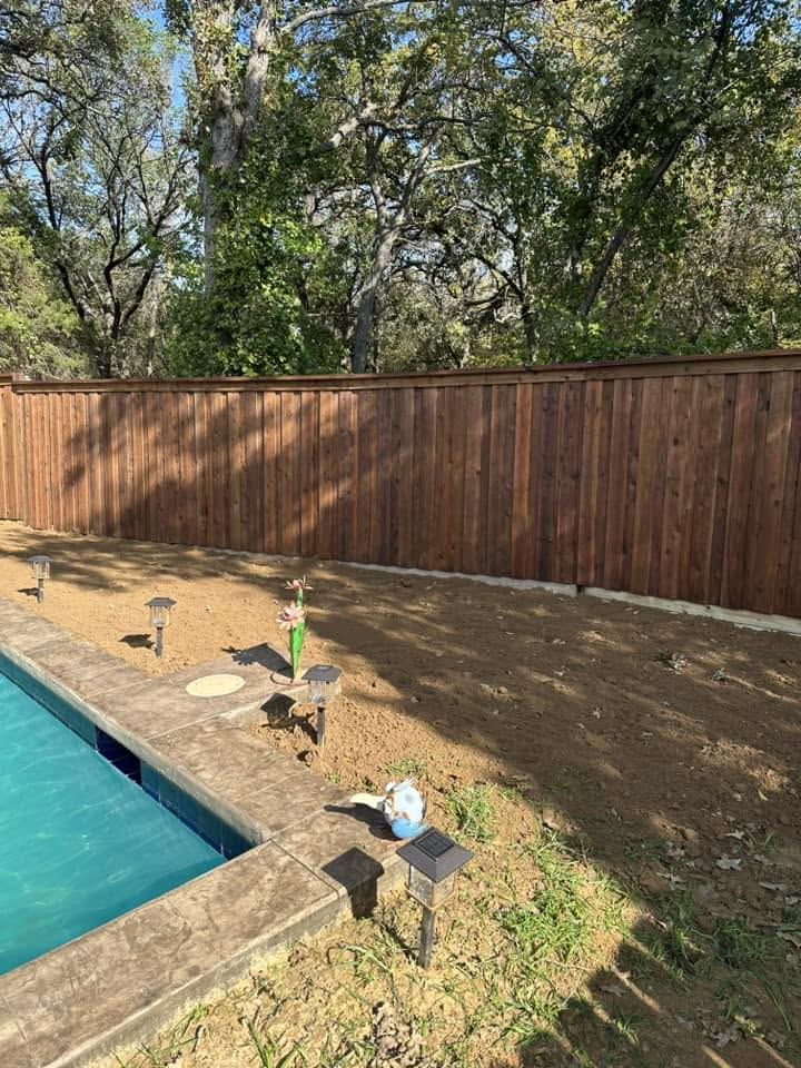 Wood privacy fence enclosing a backyard pool