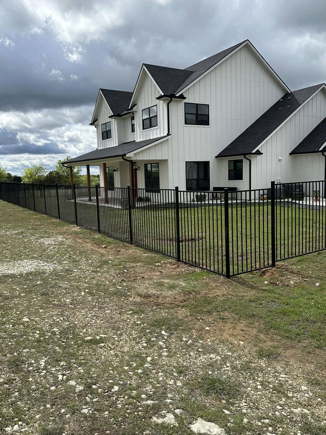 Black ornamental fence around a residential front yard